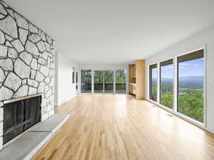 Unfurnished living room with wood finished floors and a fireplace