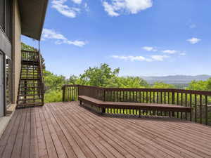Wooden deck with stairs and a mountain view