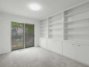 Unfurnished room featuring light colored carpet