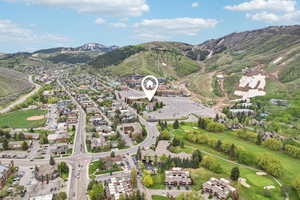 Aerial view of property and surrounding area with a mountain backdrop