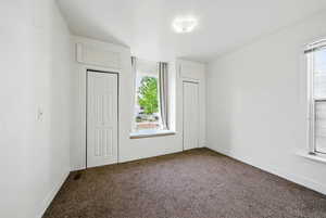 Unfurnished bedroom featuring carpet, a closet, and baseboards