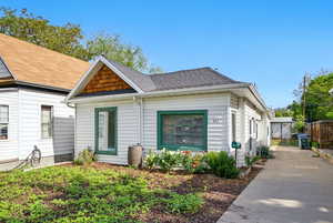 View of front facade featuring fence and concrete driveway