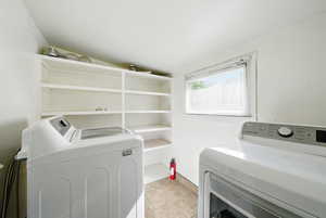 Washroom featuring washer and dryer