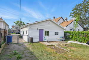 Back of property featuring a gate and a patio