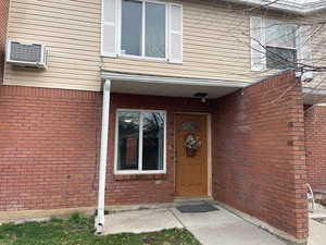 Entrance to property featuring brick siding