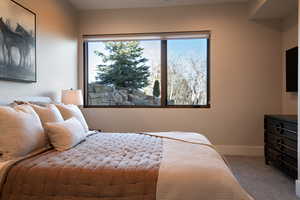 Carpeted bedroom featuring baseboards