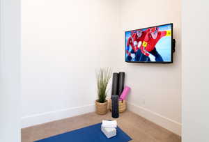 Workout room with carpet floors and baseboards
