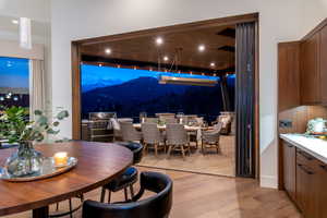 Dining room with a mountain view, light wood-type flooring, and recessed lighting