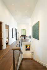 Stairs featuring wood finished floors, recessed lighting, and baseboards
