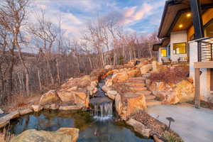View of yard featuring a small pond and stairs