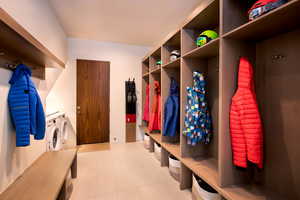 Mudroom featuring separate washer and dryer and light tile patterned flooring