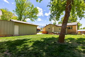 View of grassy yard and garage