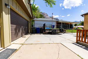 Garage featuring driveway and a mountain view