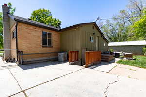 Back of house featuring a patio, AC unit and basement entrance