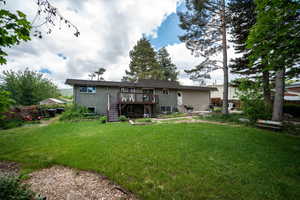Rear view of property with stairs, a deck, brick siding, and entry steps