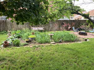 View of yard featuring a fire pit and a vegetable garden