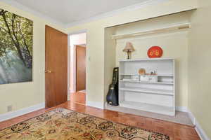 Interior space featuring baseboards and crown molding