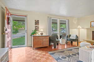 Foyer featuring a textured ceiling, crown molding, and baseboards