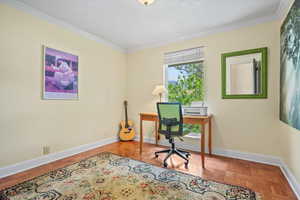 Office space featuring crown molding and baseboards