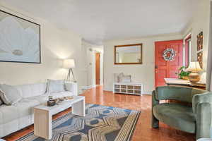 Living room featuring crown molding and baseboards