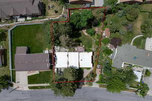 Aerial view of residential area featuring property boundaries highlighted