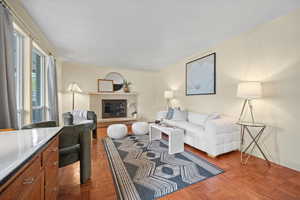 Living room with a fireplace, ornamental molding, and baseboards