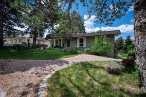 View of front of home with an attached garage and brick siding