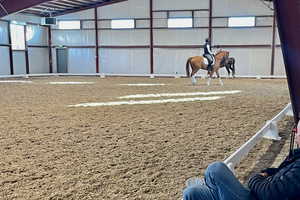The indoor riding arena features high-efficiency LED lighting and sliding windows for natural light throughout.