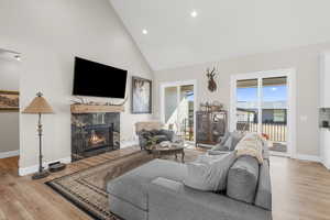 The main level showcases a warm and inviting great room with a gas fireplace and expansive windows that frame the stable and arena.