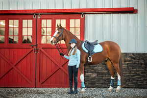 Restored vintage barn doors lead into the state-of-the-art equestrian stable and indoor arena.