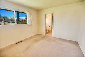 Unfurnished room with light colored carpet and baseboards