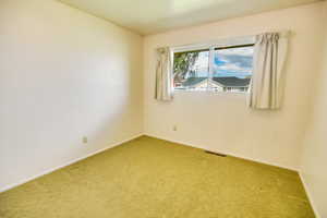 Empty room with carpet floors and baseboards
