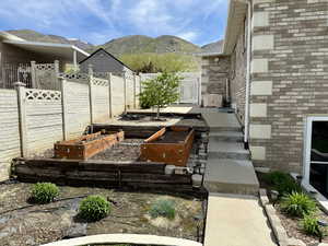 View of patio / terrace featuring a garden and a mountain view