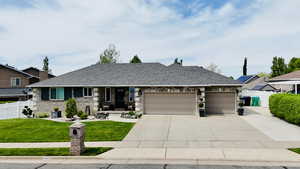 View of front of property featuring concrete driveway, an attached garage, brick siding, and a shingled roof