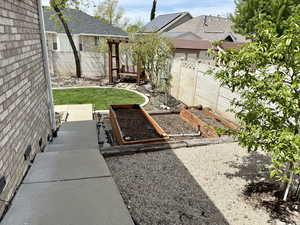 Fenced backyard with a garden