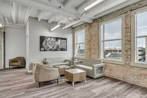 Lobby featuring brick wall and beam ceiling