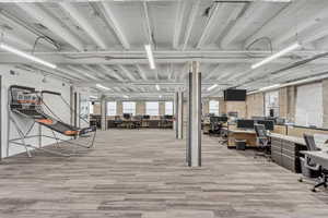 Below grade area featuring a desk and wood finished floors