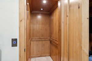 Elevator featuring recessed lighting and ornamental molding