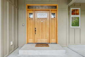 Doorway to property with board and batten siding