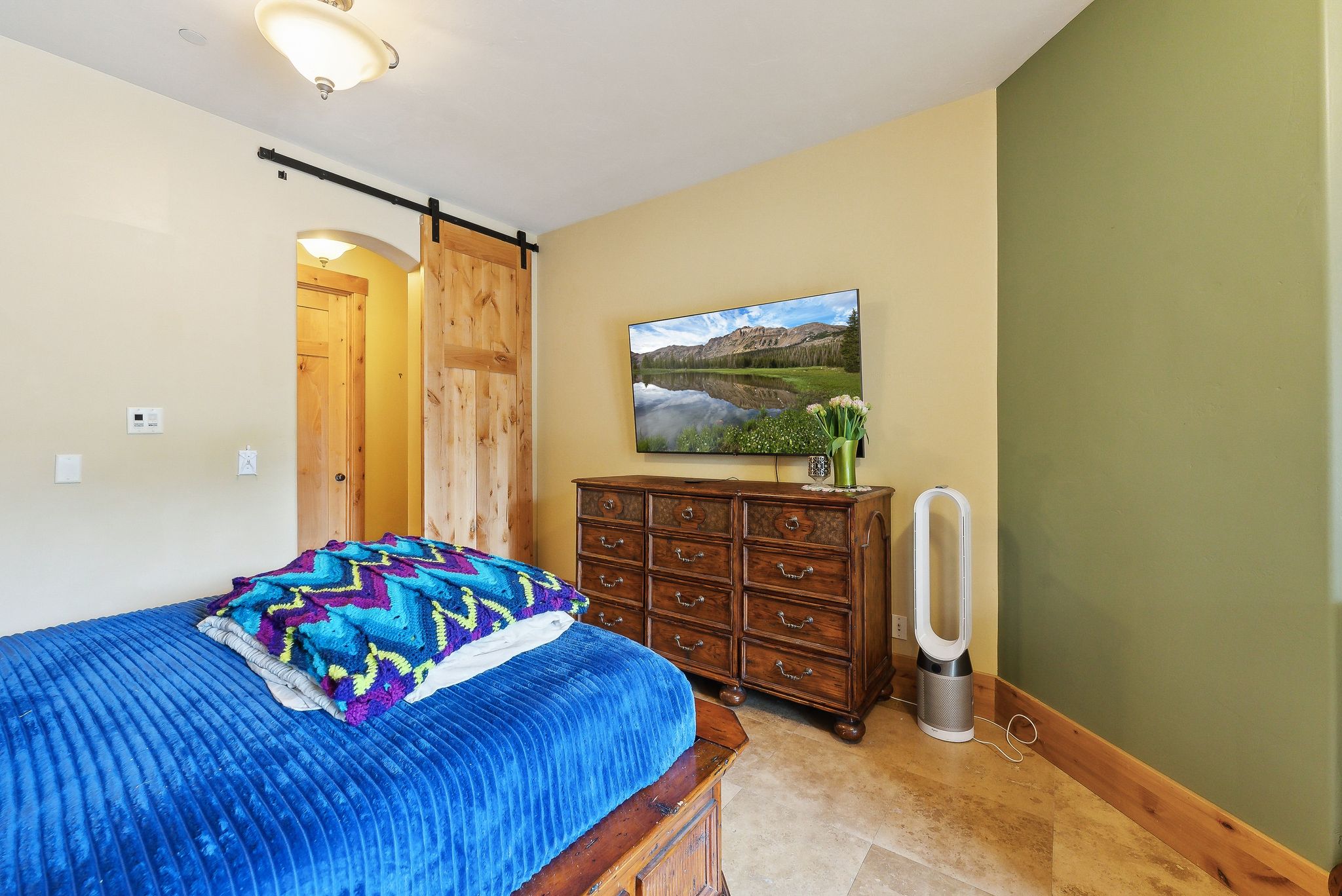 Bedroom with a barn door and baseboards