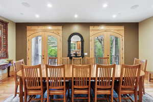 Dining room featuring french doors, plenty of natural light, light wood-style floors, and recessed lighting