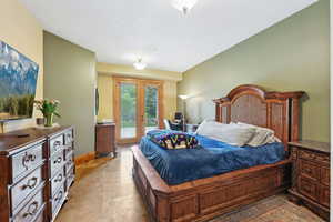 Bedroom with access to exterior, baseboards, and light tile patterned floors
