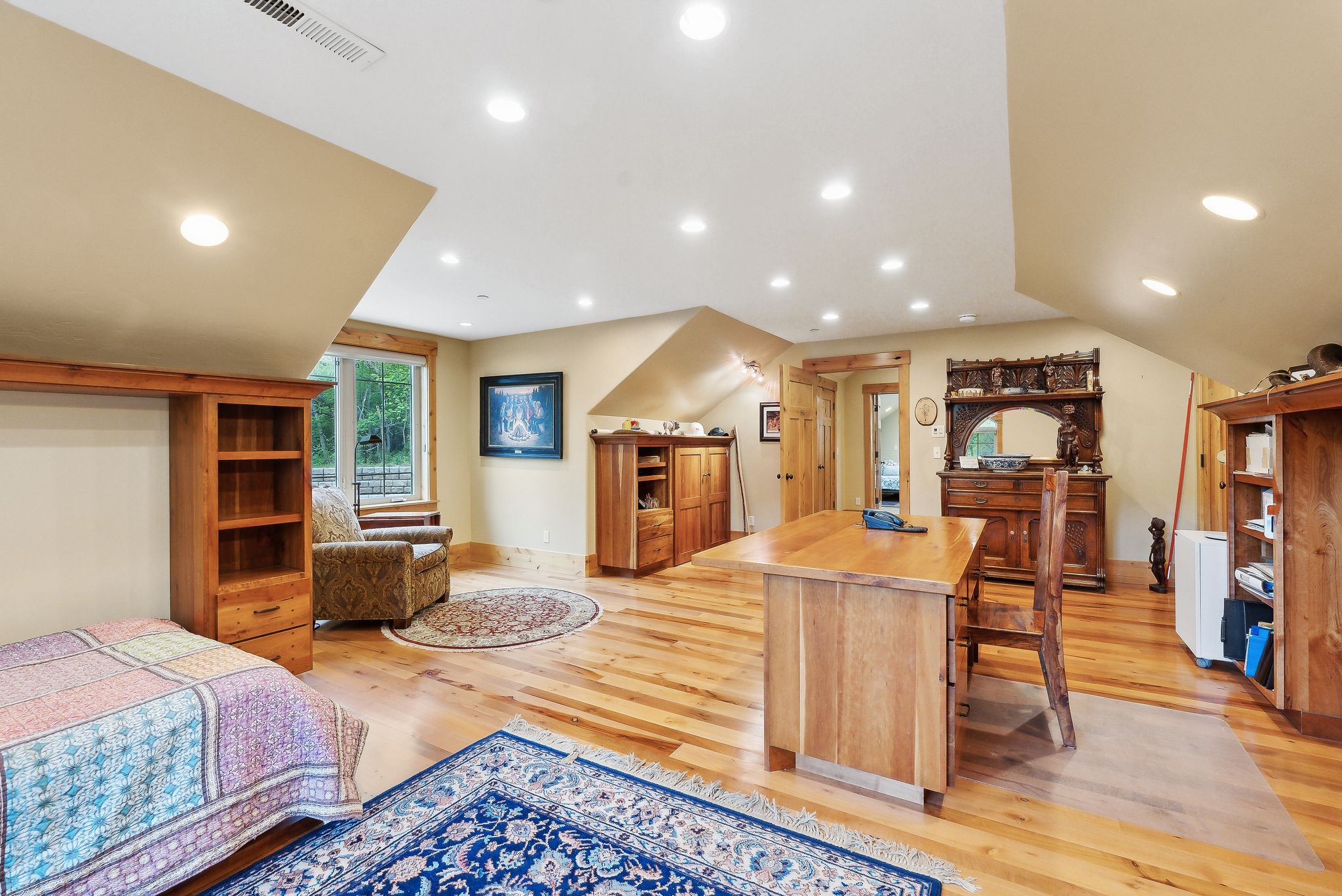 Bedroom with light wood-style floors, recessed lighting, and baseboards