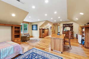Bedroom with light wood-style floors, recessed lighting, and baseboards