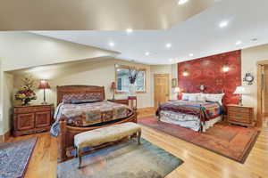 Bedroom with wood finished floors and recessed lighting