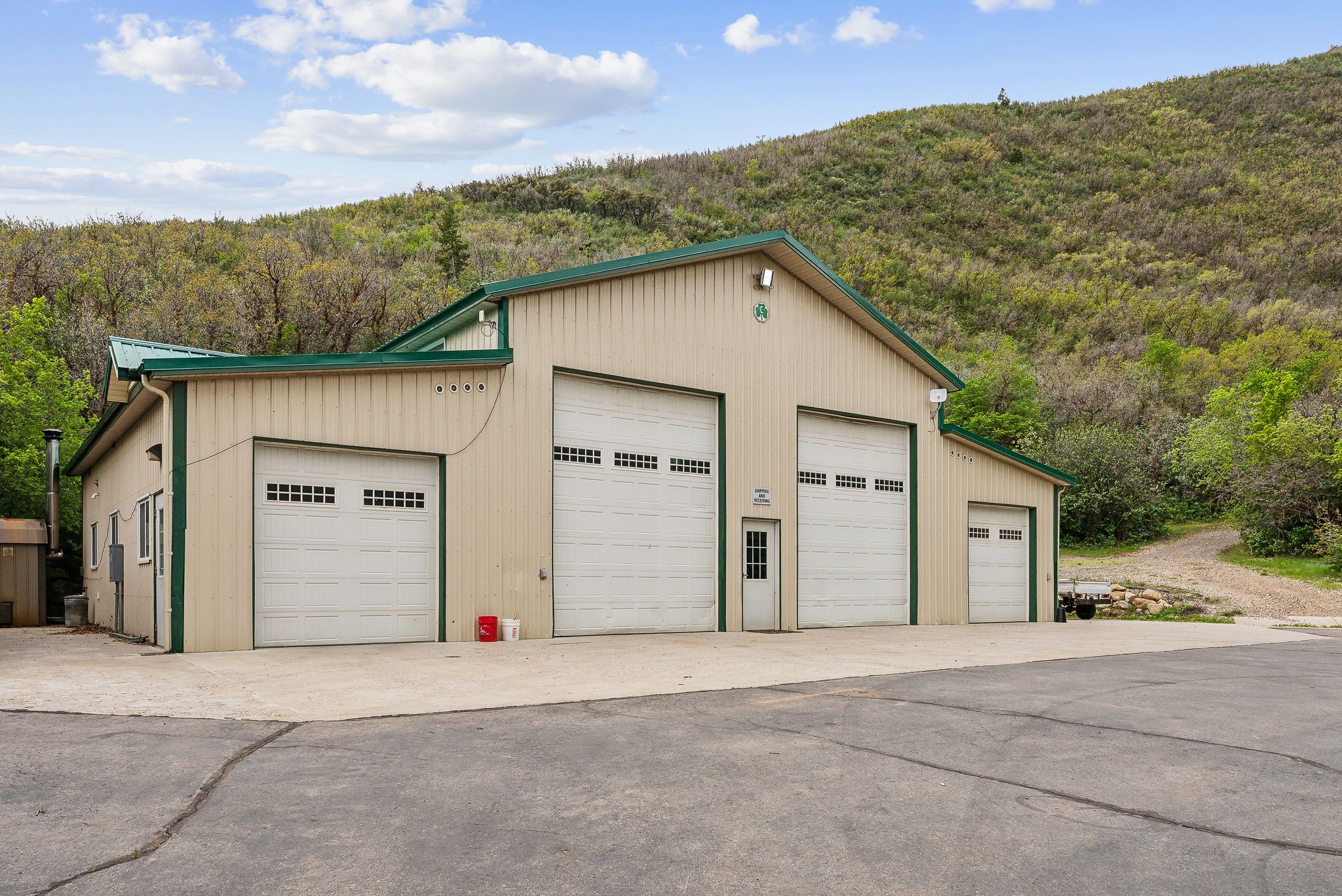 Detached garage featuring a wooded view