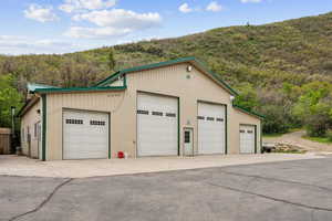 Detached garage featuring a wooded view