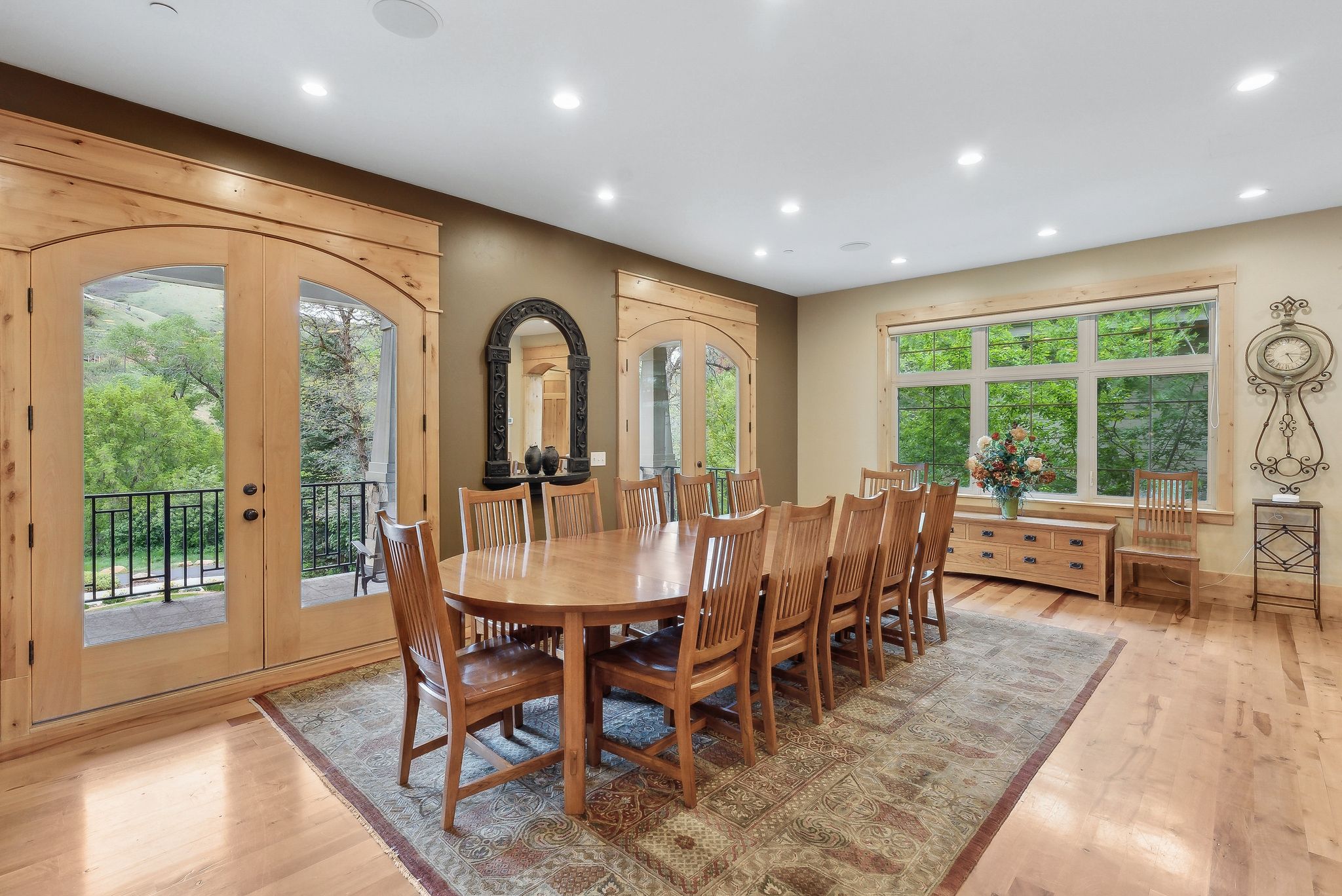 Dining space with french doors, recessed lighting, light wood-type flooring, and arched walkways
