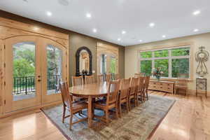 Dining space with french doors, recessed lighting, light wood-type flooring, and arched walkways