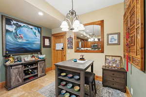Dining room featuring a chandelier, baseboards, and recessed lighting